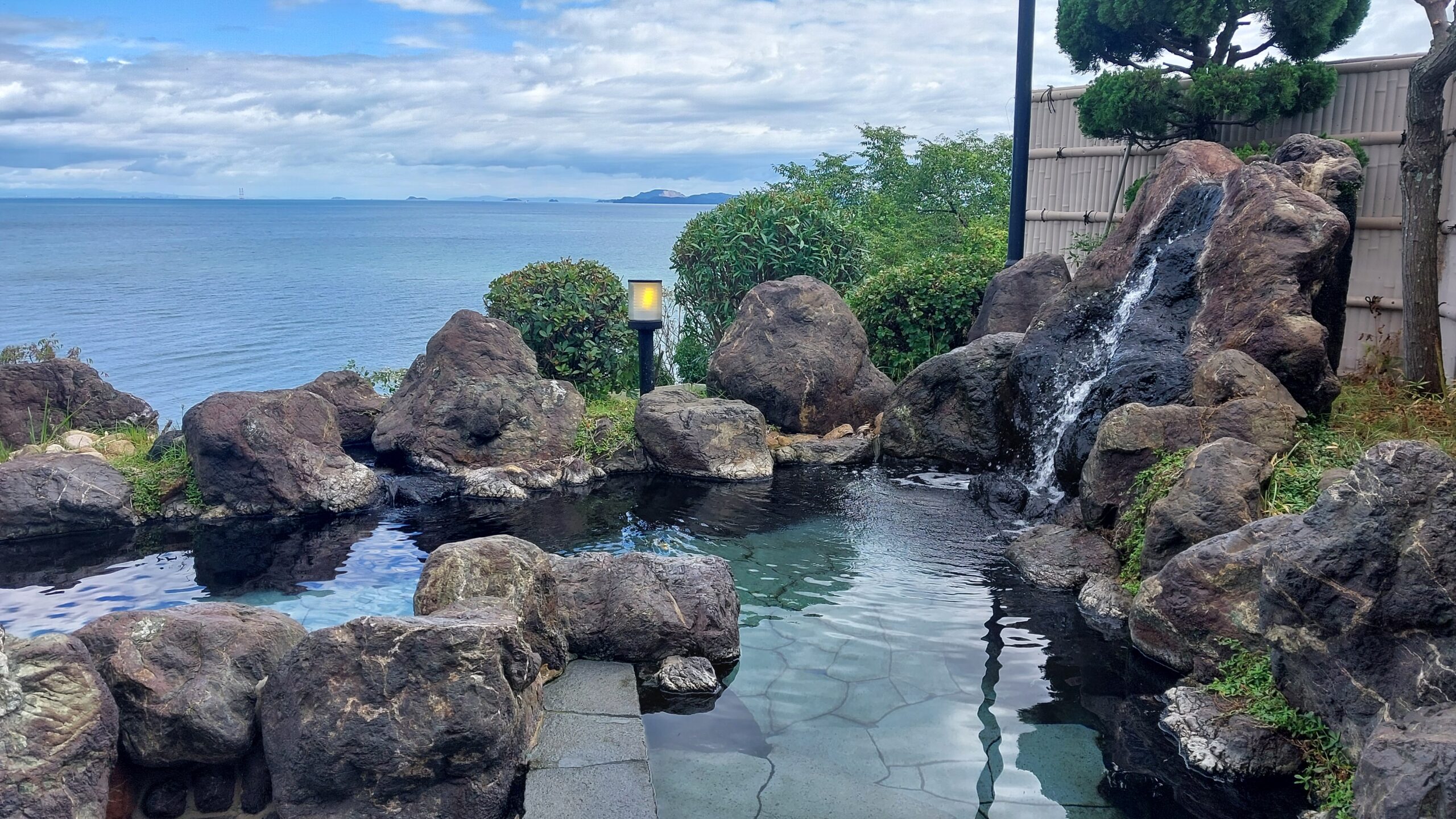 An outside onsen (hot spring) overlooking the ocean.